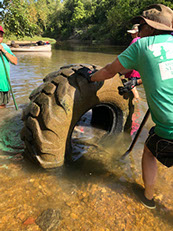 ST 5645 tackling a huge tire in the stream